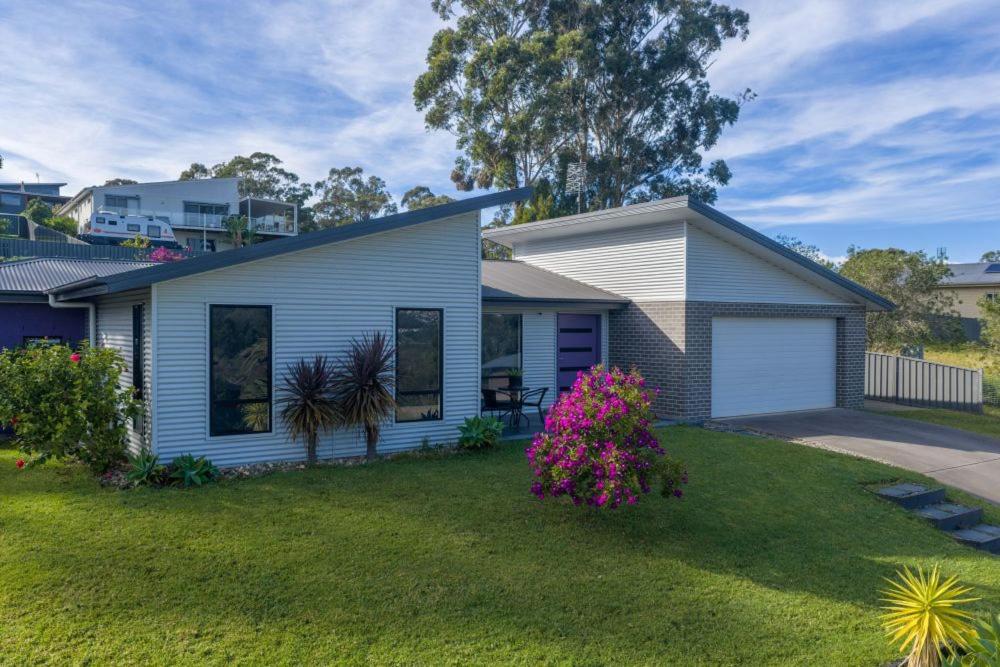 a house in a yard with a green lawn at Marlin Vista - Pet Friendly in Eden