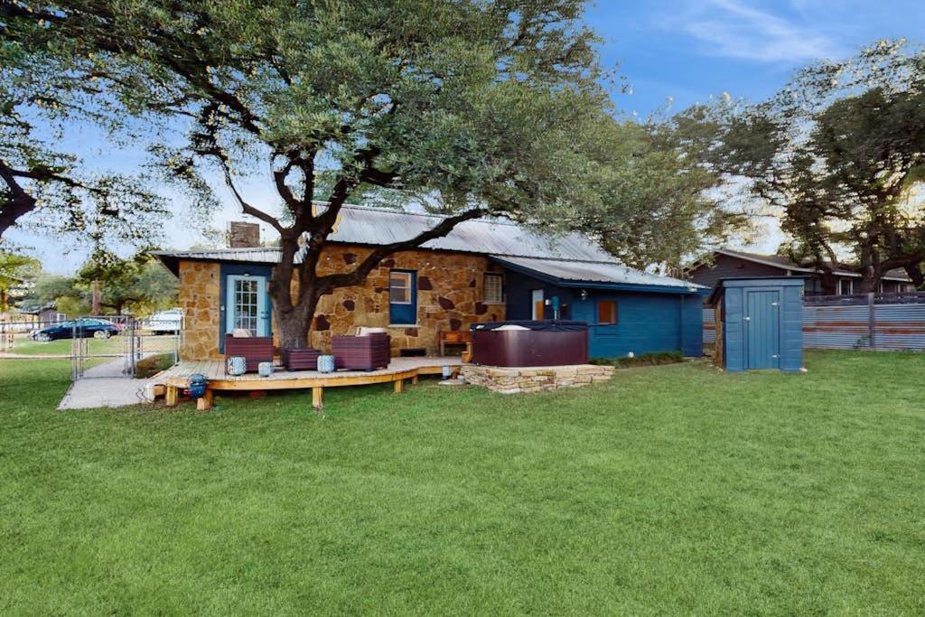 a stone house with a tree in a yard at Blue Haus with Hot Tub, Shuffleboard, EV Charger - Walk to Town & Wineries in Johnson City