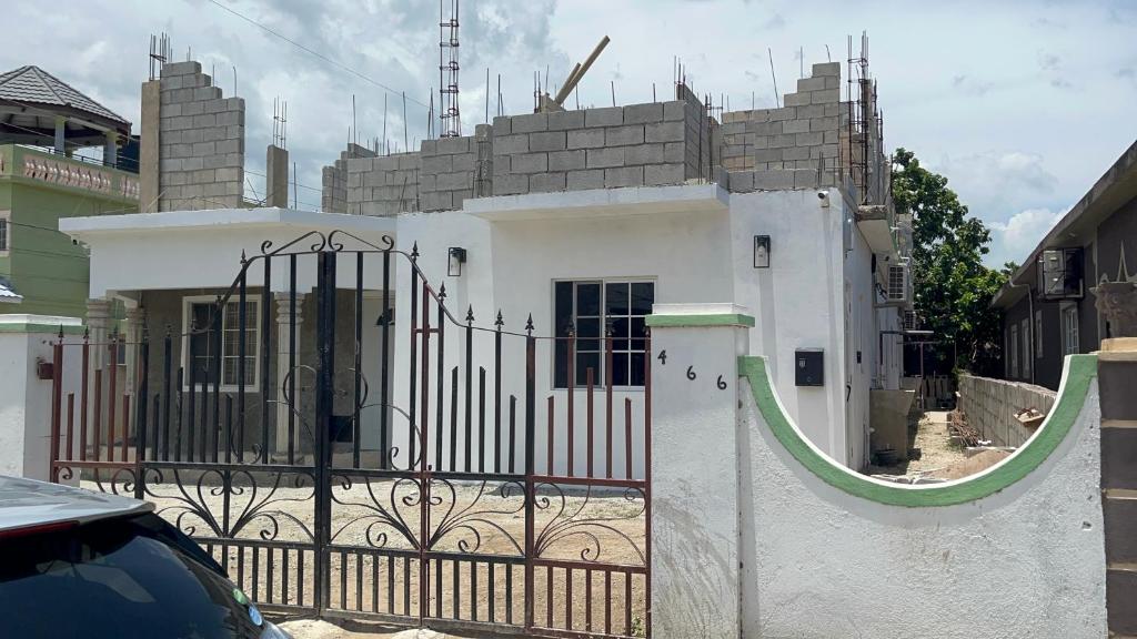 a building under construction with a gate in front of it at Ricardo's Rest Spot in Curatoe Hill