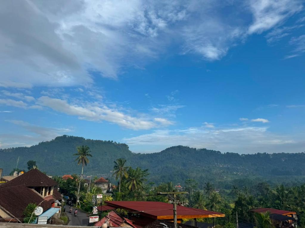 a view of a resort with mountains in the background at Swariguna homestay in Sidemen