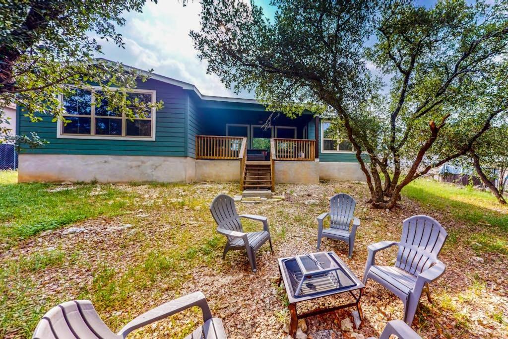 a group of chairs and a table in front of a house at Cozy Lago Vista Home with Private Pool Table, Mile From The Stunning Lake Travis in Lago Vista