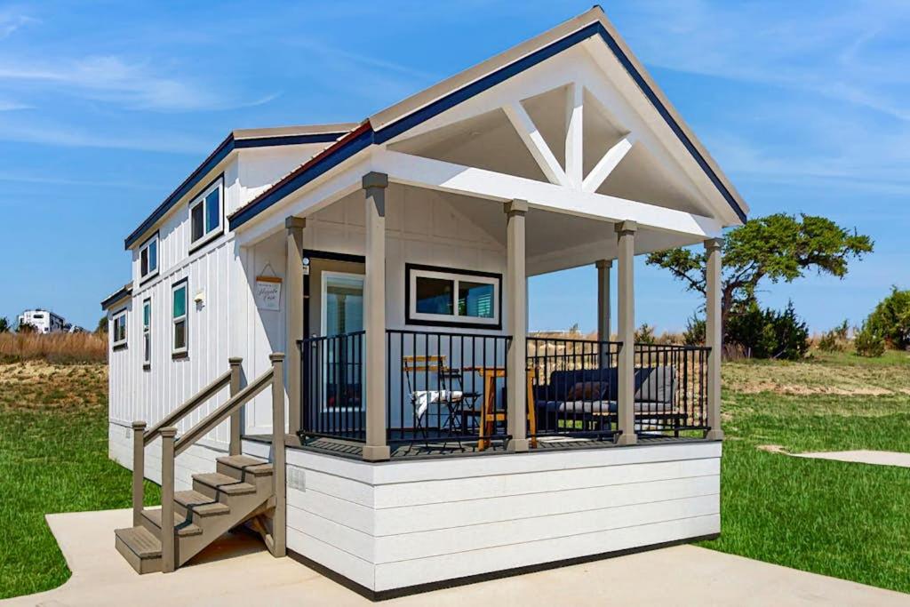 a tiny house with a porch and a deck at Modern Tiny Home with Loft, Kitchen, Cozy Patio and Shared Pools, Great Location in Fredericksburg