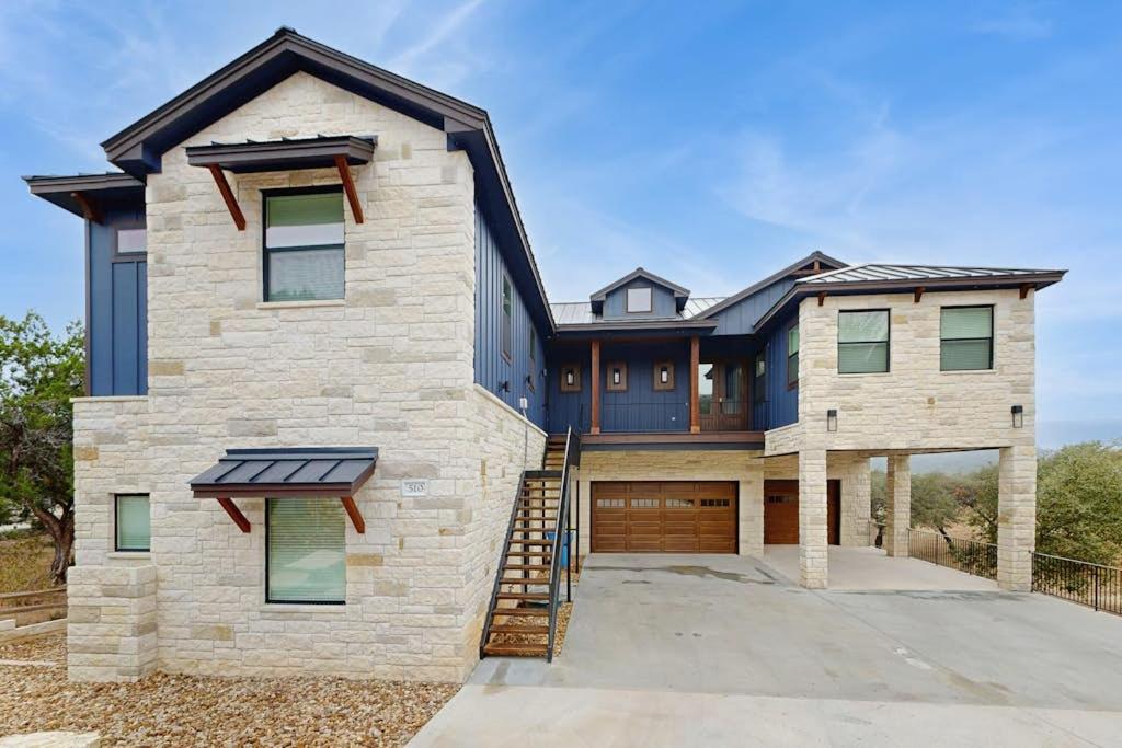 a large brick house with a garage at Spacious House with Ping-Pong and Pool Table, Balcony with Water and Sunset View in Point Venture