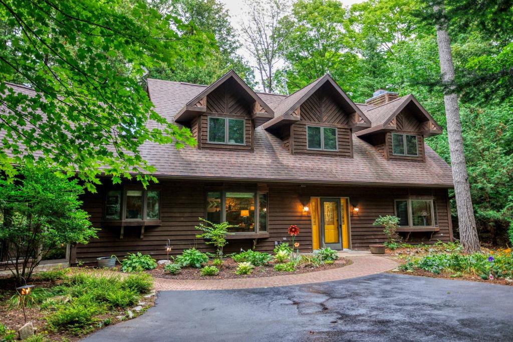 a wooden house with a gambrel roof at Asher Manor by Simple Life Rentals in Egg Harbor