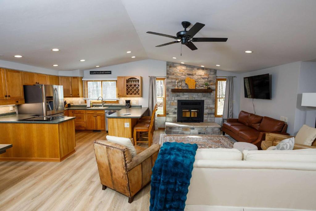 a living room with a white couch and a kitchen at Grateful Roots in Egg Harbor