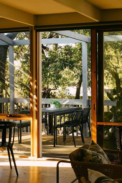 a patio with a table and chairs on a porch at The Angle House - Aireys Inlet in Aireys Inlet