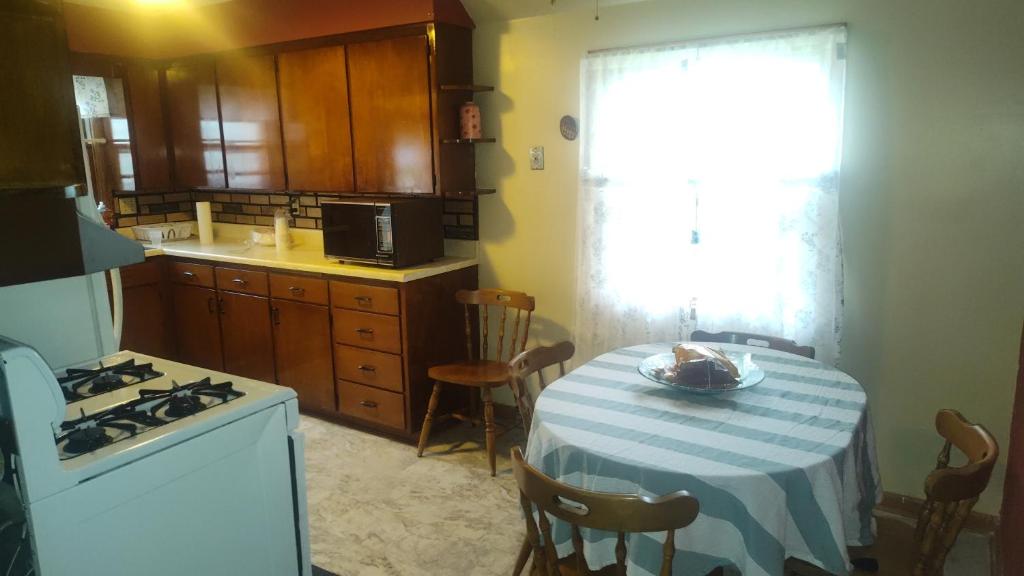 a kitchen with a table with a blue and white table cloth at The Sparkle House in Cedar Rapids