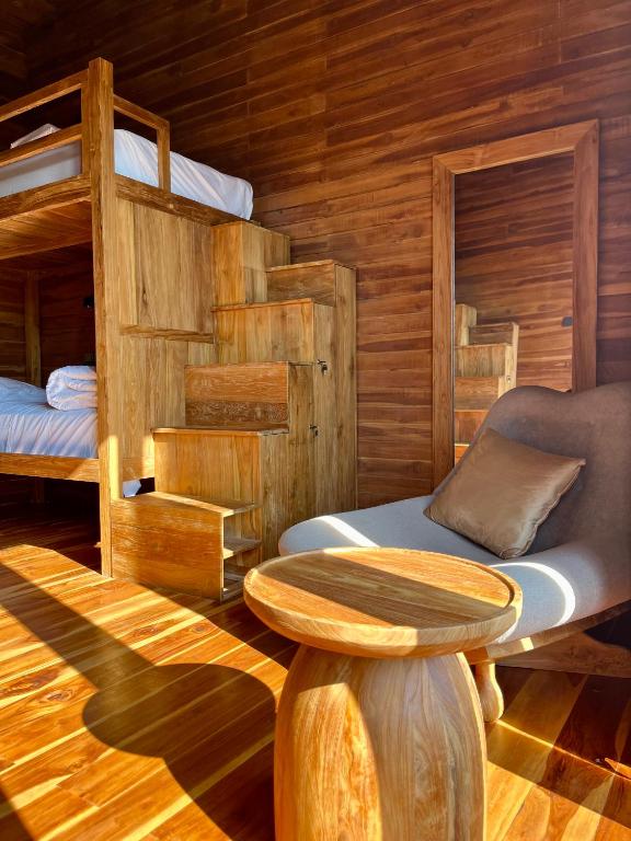 a room with two bunk beds and a table at Wavedance Bali Surfhouse in Airsatang