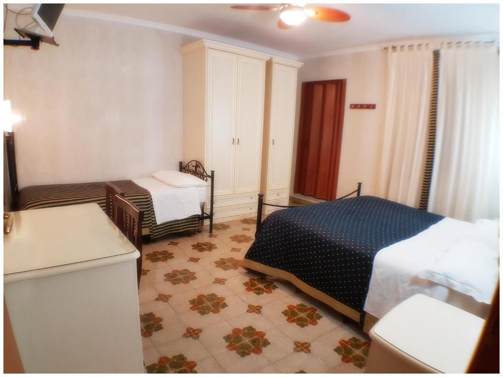 Postel nebo postele na pokoji v ubytování Hotel Pisani