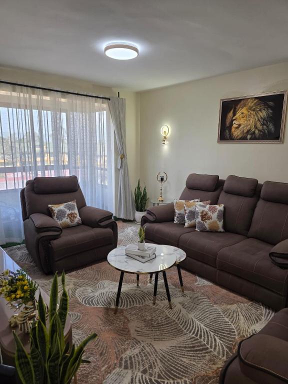 a living room with a couch and a coffee table at Savanna Living in Nakuru