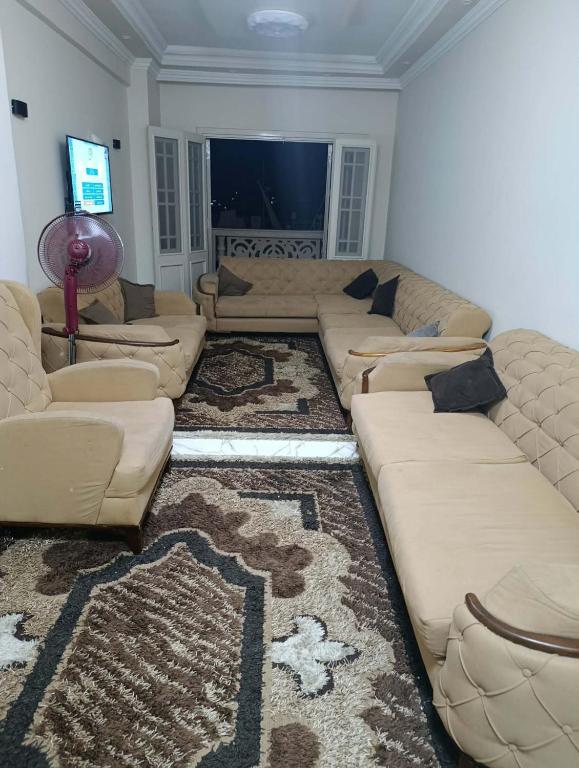 a living room with a couch and a rug at Holiday apartment in ‘Izbat al Waqf