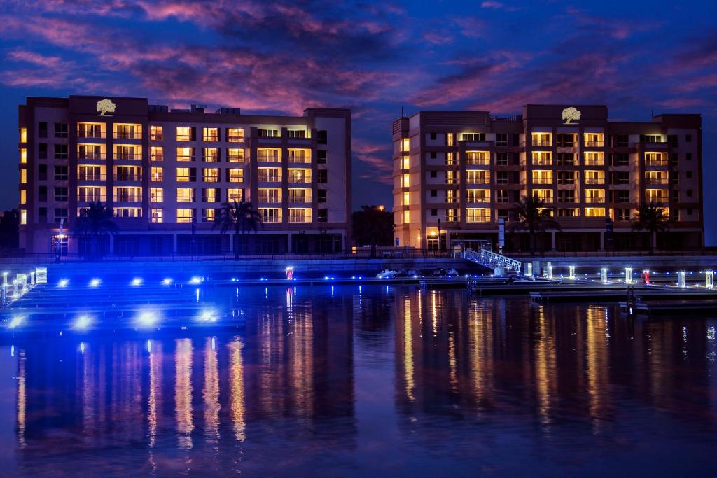 a city with buildings and a river at night at Jannah Hotel Apartments & Villas in Ras al Khaimah