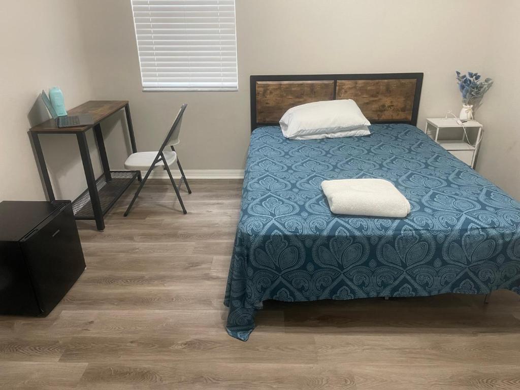 a bedroom with a bed and a desk and a chair at Dolphin Room in Tampa