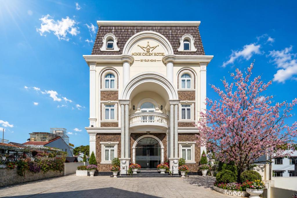 a large white building with a tower at Minh Chien Hotel in Da Lat