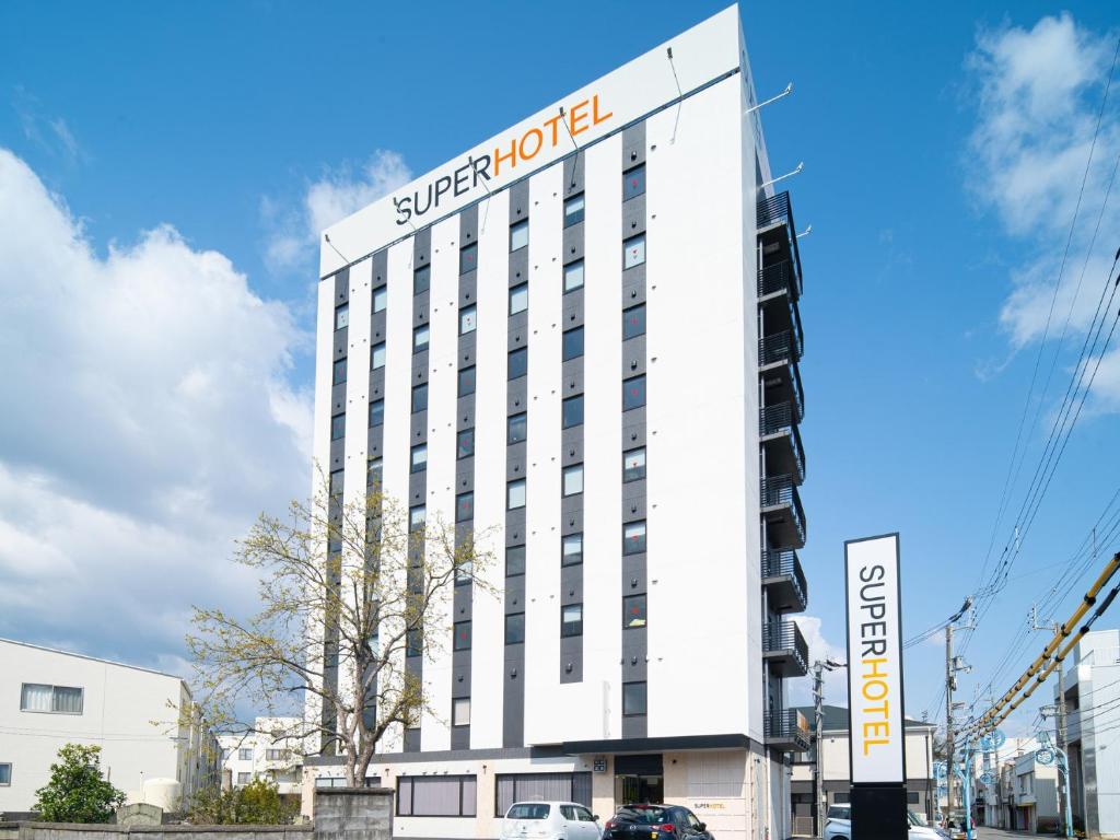 a building with a sign for a hotel at Super Hotel Anan City Hall Smoke-Free in Anan