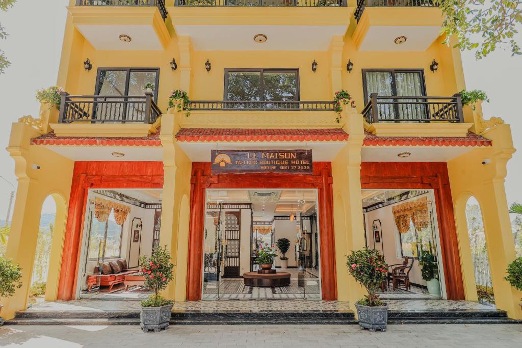 a large yellow building with an entry way at Le Maison Tam Coc Boutique Hotel in Ninh Binh