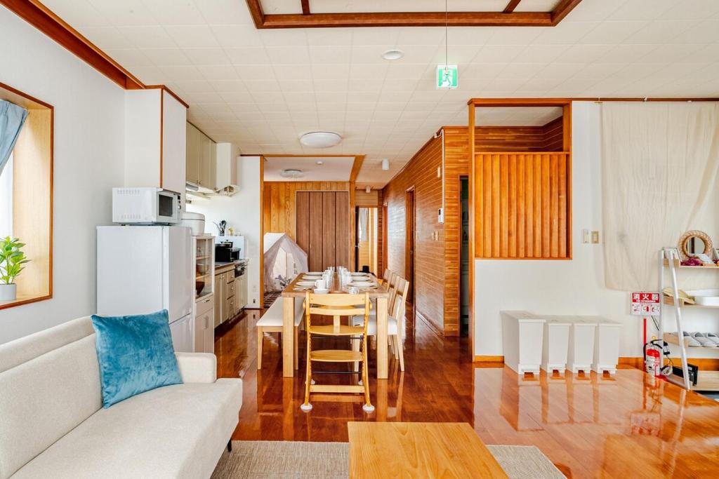a living room with a white couch and a table at Rela More in Ginowan