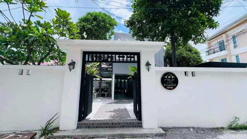 a white entrance to a building with a black door at Villa Wongamat in North Pattaya