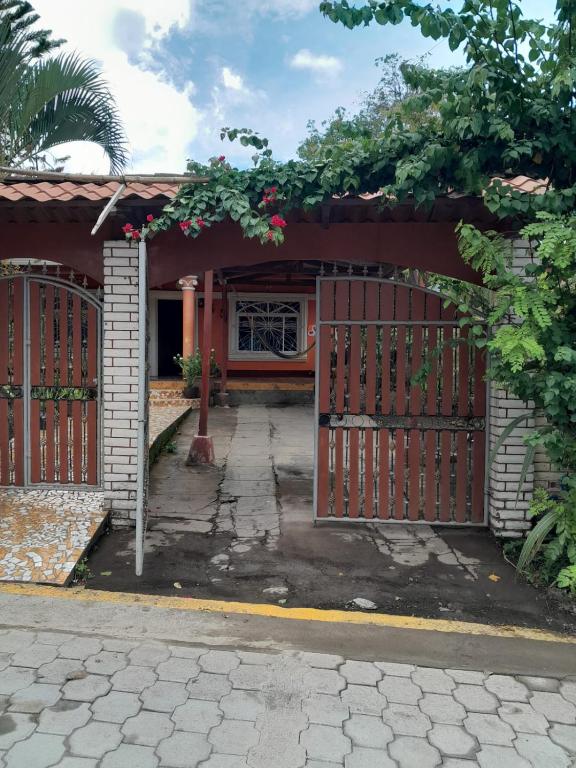 an entrance to a house with a wooden gate at CASA MARCELa in Altagracia