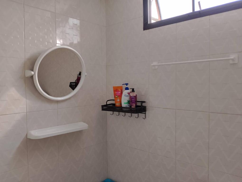 a white bathroom with a mirror and a shower at Jr - House 2 34-103 in Ban Talat Rangsit