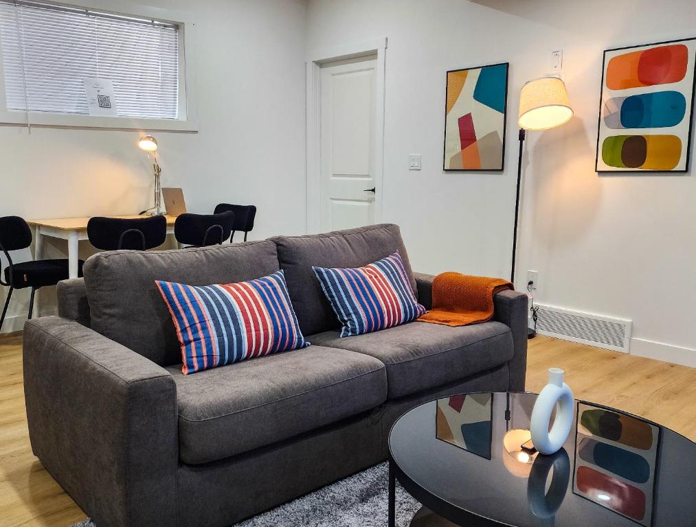 a living room with a couch and a table at TNC Stays Luxurious Modern Suite Seton Calgary South in Calgary