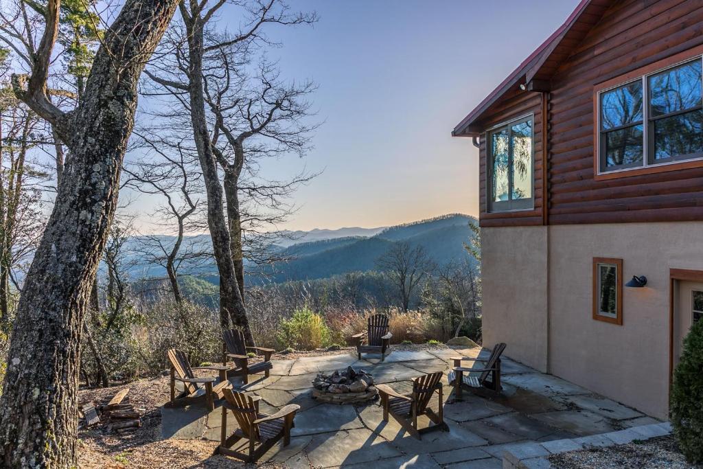 a patio with chairs and a fire pit next to a house at Alpine Vista in Lenoir