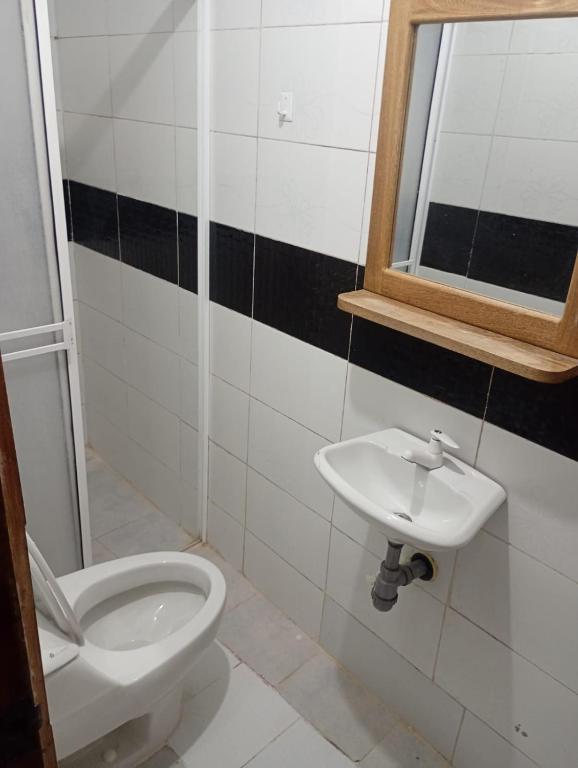 a bathroom with a toilet and a sink at Hospedaje Meriland in Guayabal