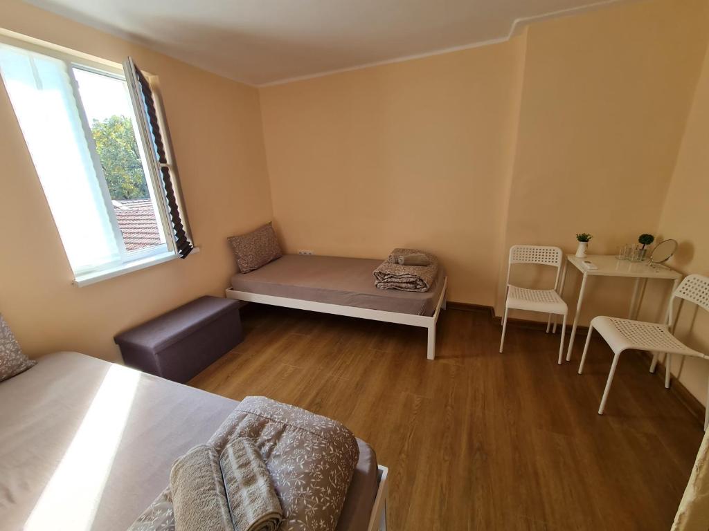 a small room with a bed and a table at XAH - HAN Plovdiv Center in Plovdiv