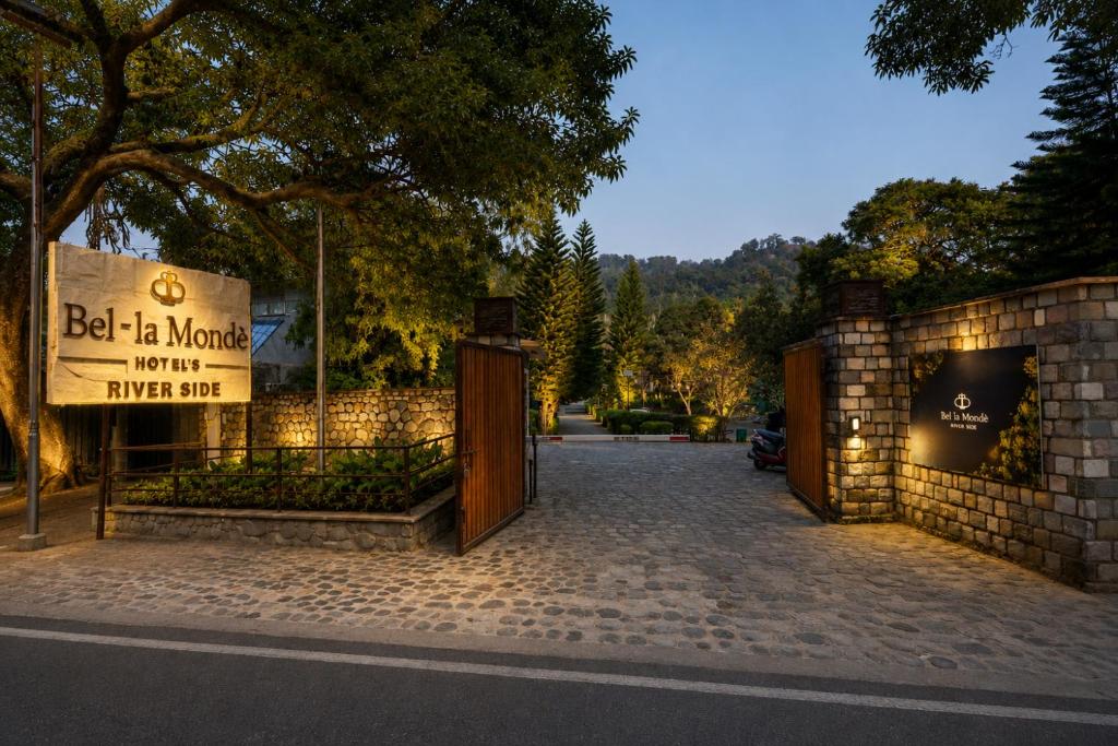 a gate with a sign that reads bed is mongolia hotel upper bid at Bel-La Monde Riverside Jim Corbett - "A Unit of Luxe Opera Hotels & Resorts" in Garjia