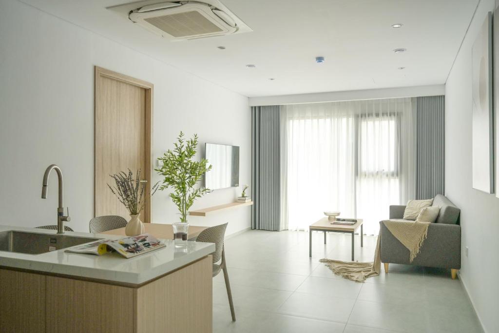 a kitchen and living room with a couch and a table at TS Apartment in Hanoi