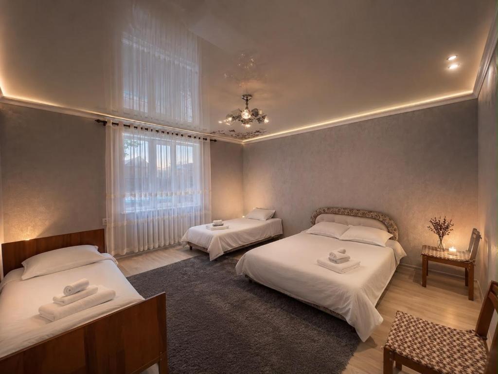 a bedroom with two beds and a window at Green in Bokonbayevo