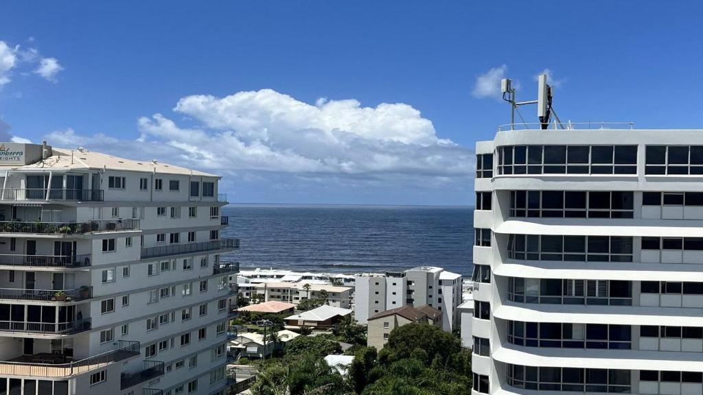 a view of the ocean from between two buildings at The Pinnacles Caloundra Unit 92 in Caloundra