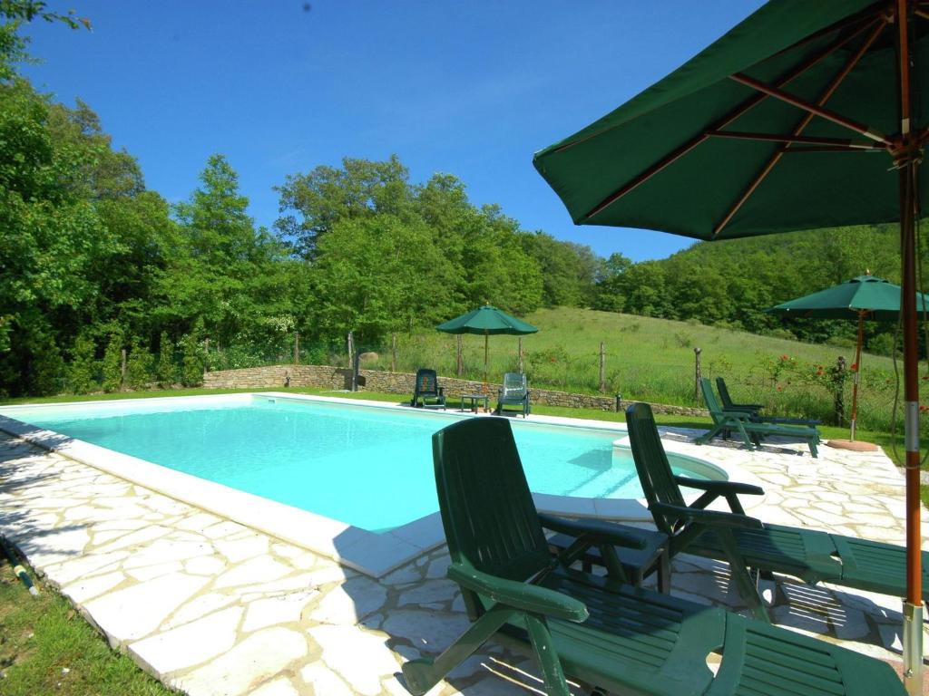 CasellaにあるLuxury Cottage in Lisciano Niccone Umbria with Swimming Poolのスイミングプール(椅子2脚、パラソル付)