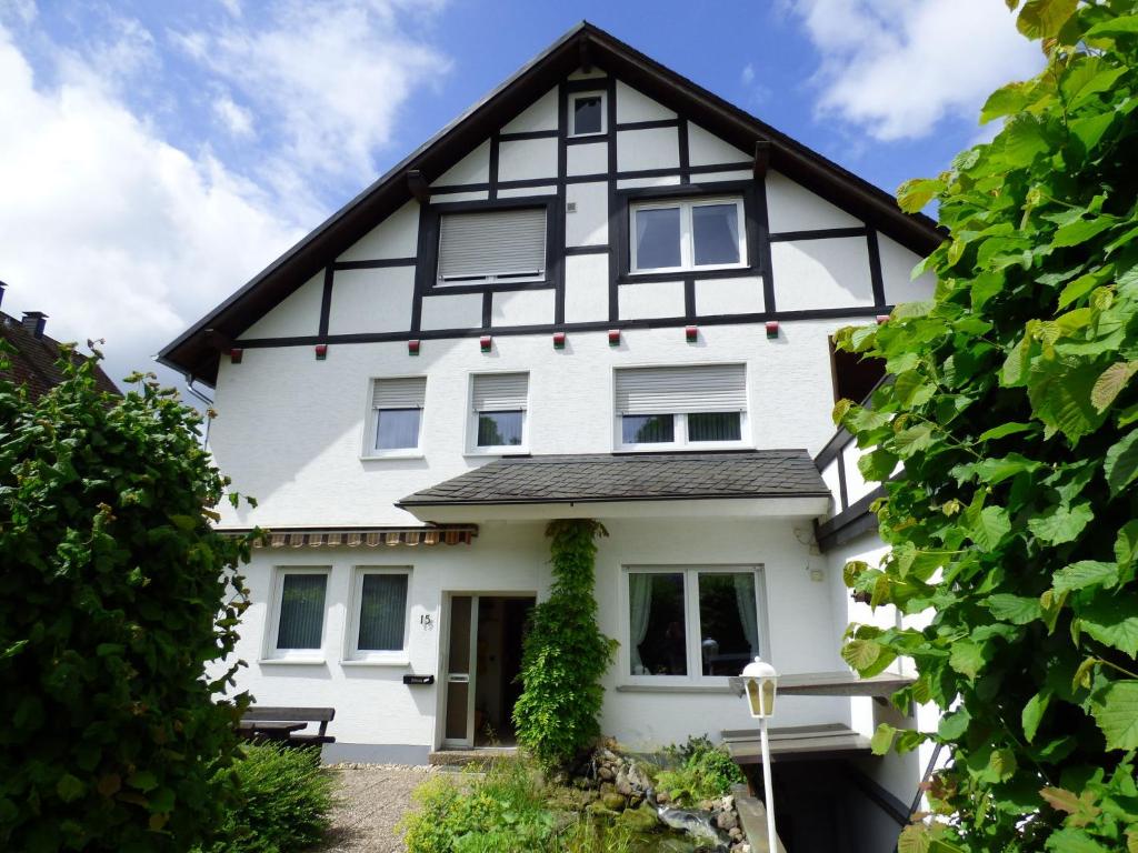 a white house with a black roof at Apartment in Assinghausen with a Sun Terrace in Assinghausen