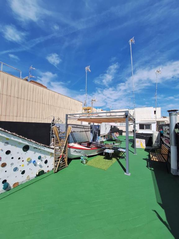 a deck of a ship with a boat on a green floor at Orisol in Vinarós