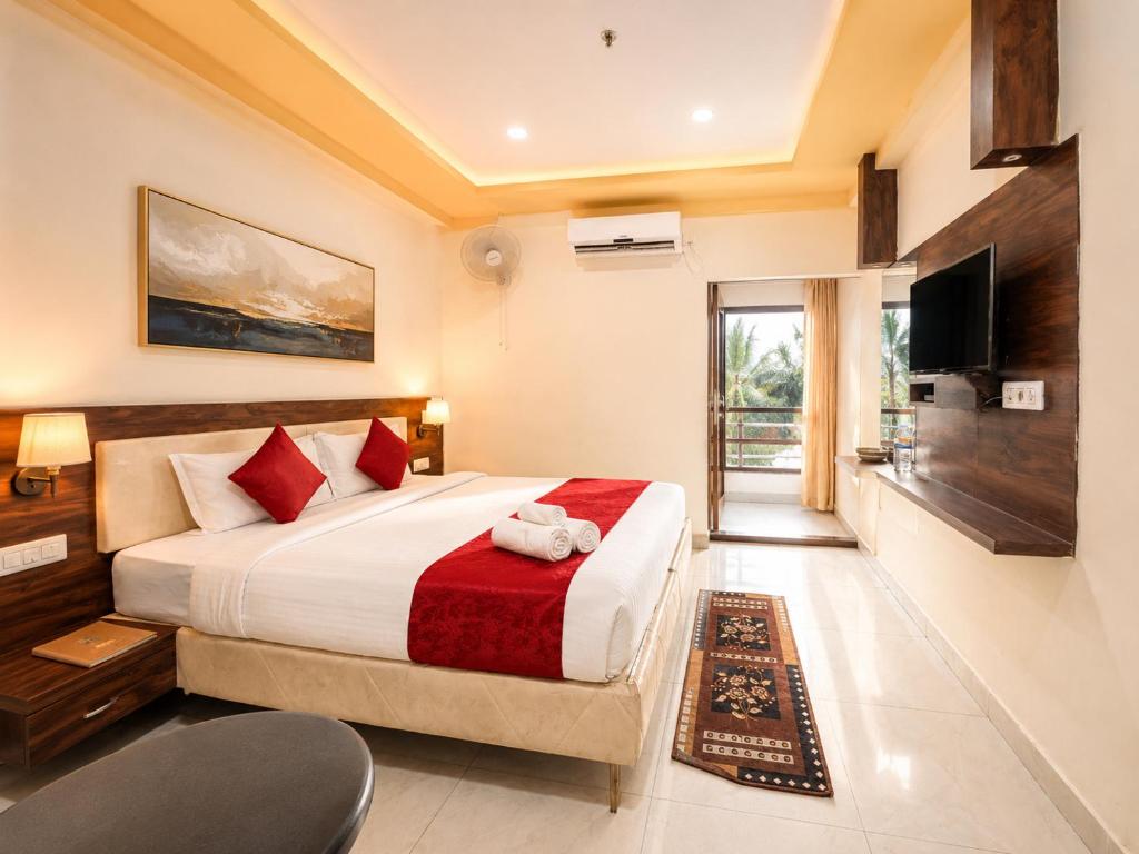 a bedroom with a large bed and a television at BEN-SEN Puri #Affordable # S-Pool in Puri