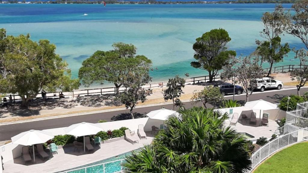 an aerial view of a resort with a pool and the beach at The Moorings Unit 508 in Golden Beach