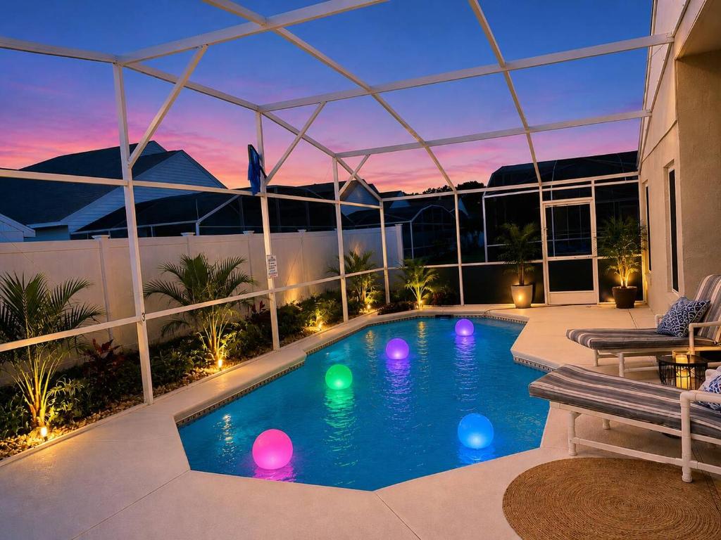a swimming pool with lights in the middle of a house at Villa Brittany Private Pool • Close to Disney in Kissimmee