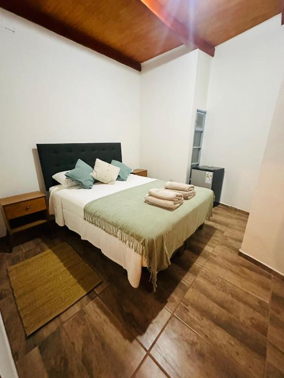 a bedroom with a bed with towels on it at Casa Ckunna in San Pedro de Atacama