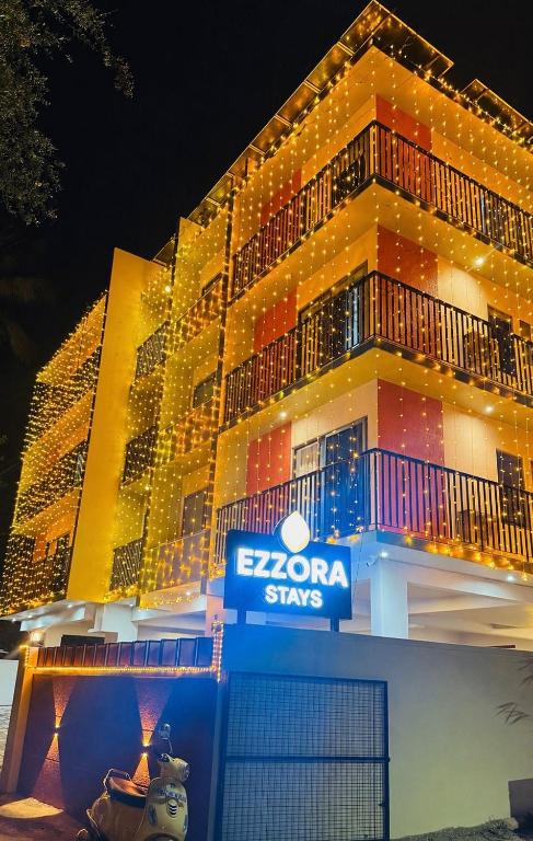 a lit up building with a sign on it at Ezzora Stays in Kozhikode