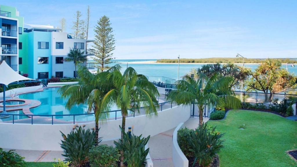 a resort with a swimming pool and a view of the water at Grand Pacific Unit 19 in Caloundra