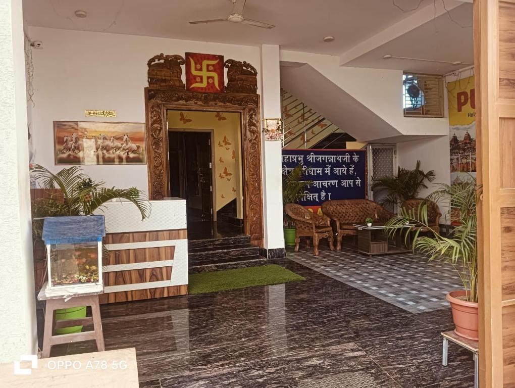a lobby of a building with a sign on the door at TITILI PLAZA in Puri