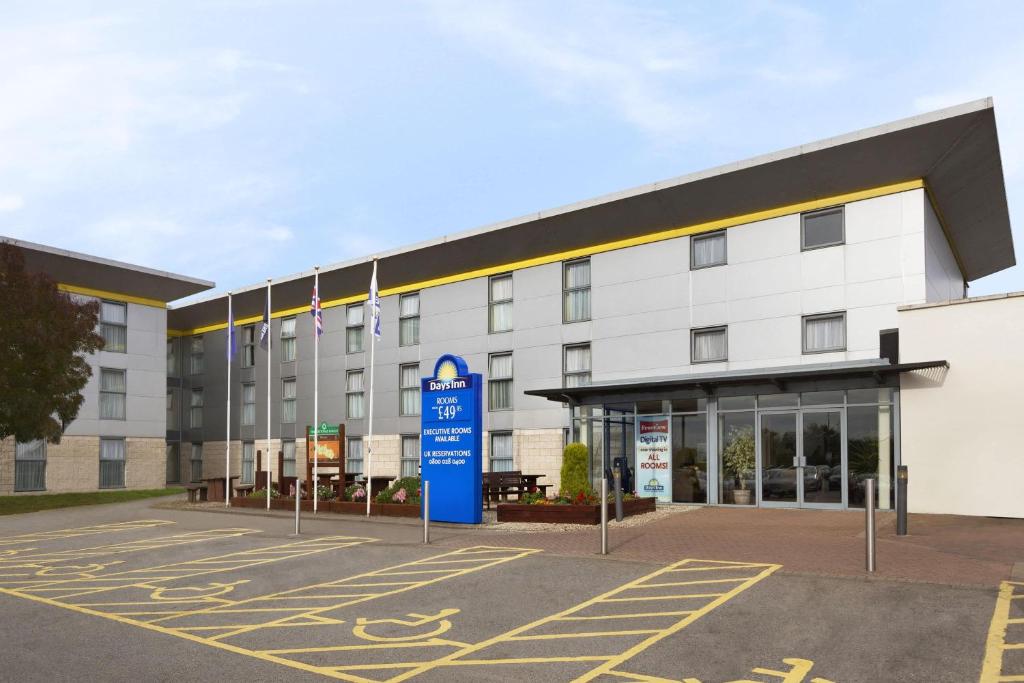 an empty parking lot in front of a hospital at Days Inn Hotel Leicester in Leicester