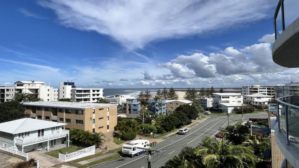 a view of a city with buildings and the ocean at Seabourn Unit 502 in Caloundra