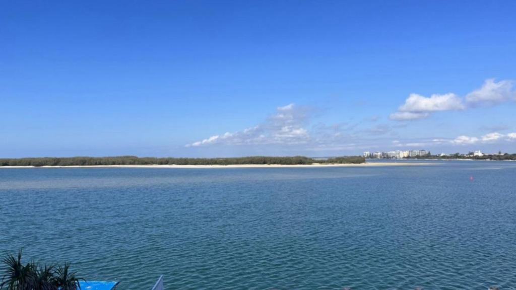 a large body of water with a mountain in the background at Pumicestone Chase Unit 5 in Caloundra