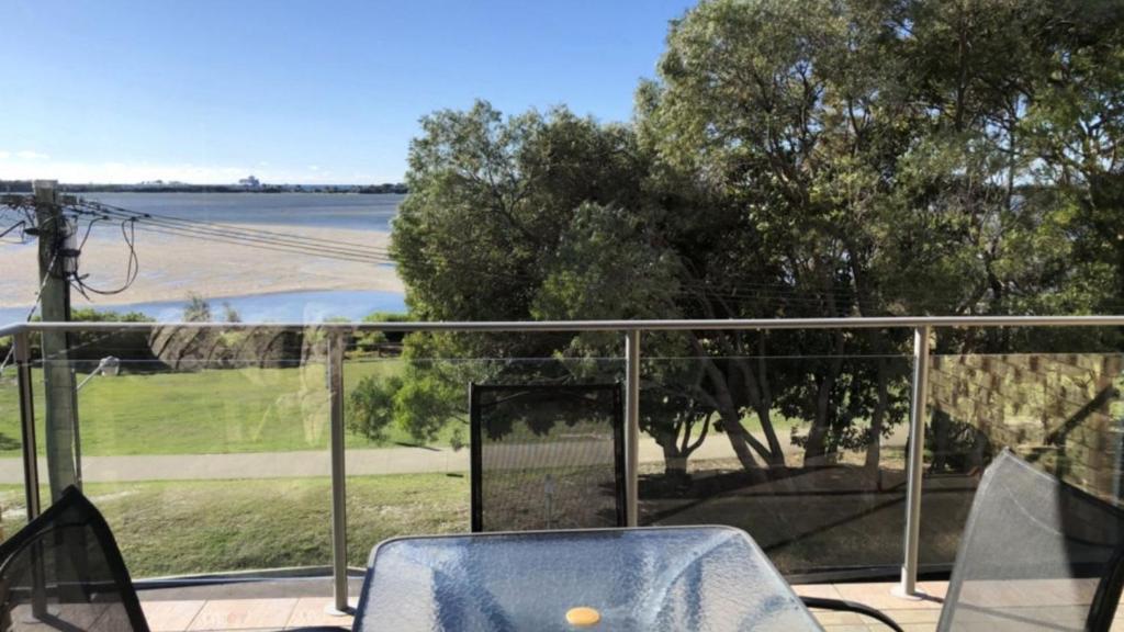 a balcony with a chair and a view of a field at Sorrento Unit 5 in Golden Beach