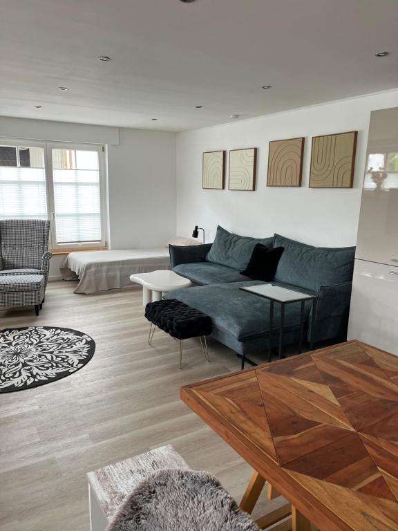 a living room with a couch and a table at Hof Busen Farm Haus in Mönchengladbach