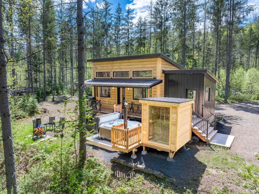 a tiny house in the woods in a forest at Spa & Riverside - Le Ptit Cool Des Bois in Trois Rives