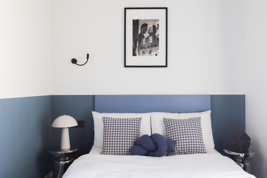 a bedroom with a bed with a teddy bear on it at Solo Society Hybrid Hotel Vilnius in Vilnius