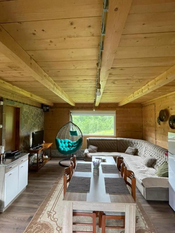 a living room with a couch and a table at Mountain House Jelovica in Berane
